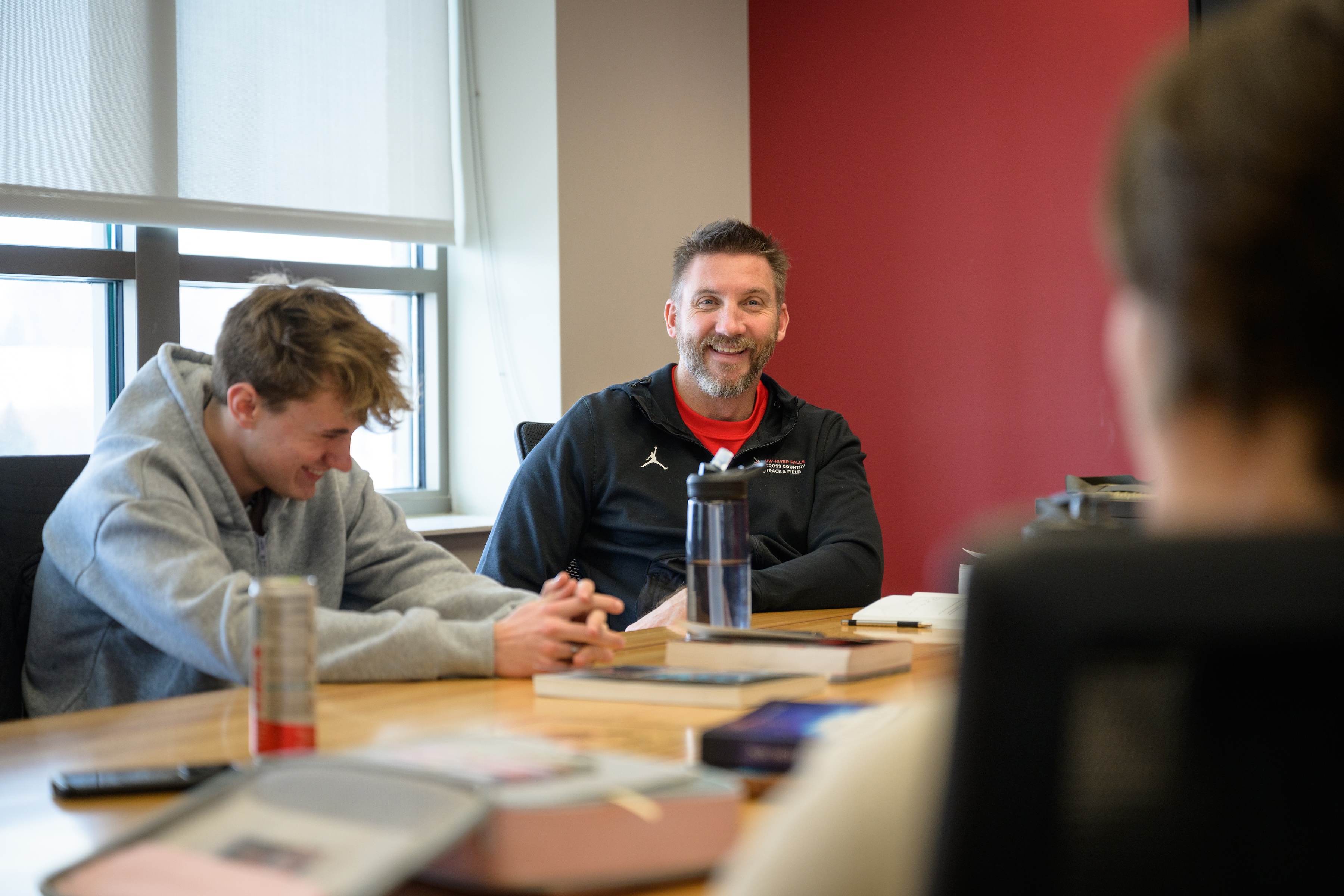 Coach Andy talking to two Core Leaders