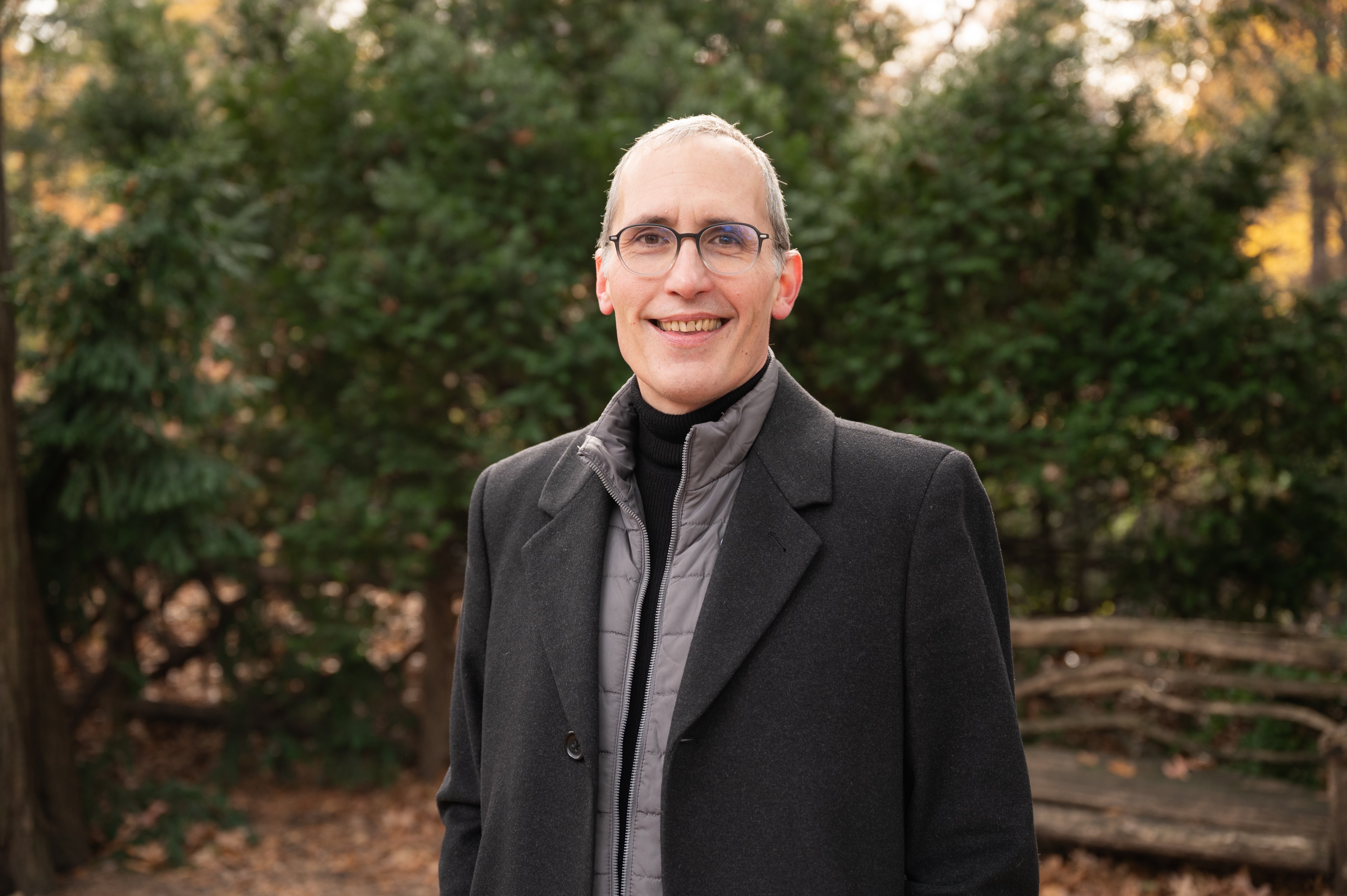Jason smiling with a nature background