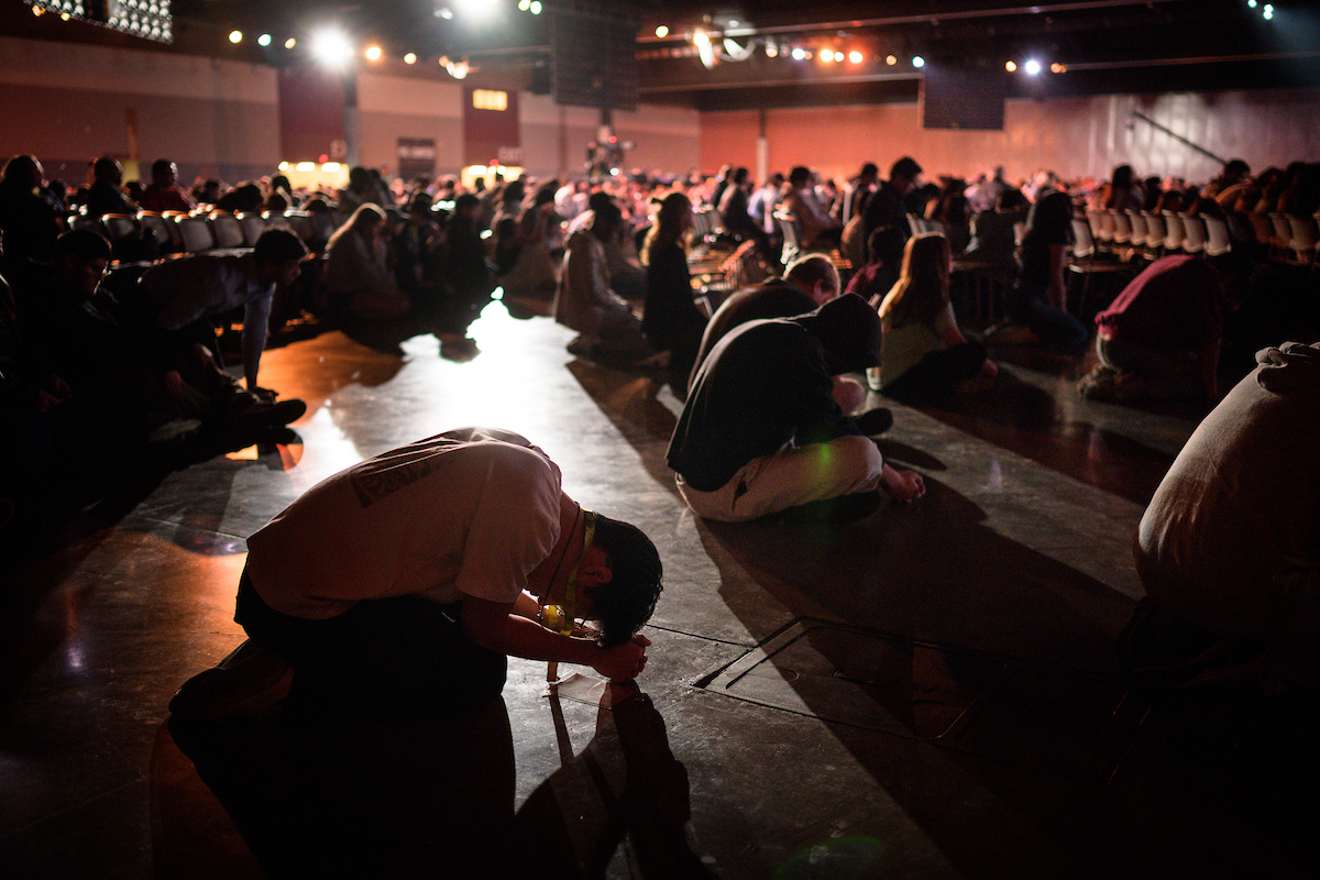 Students kneel in surrender.