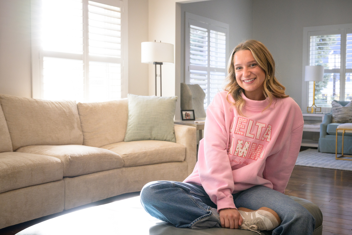 Ava in a pink sweater smiling