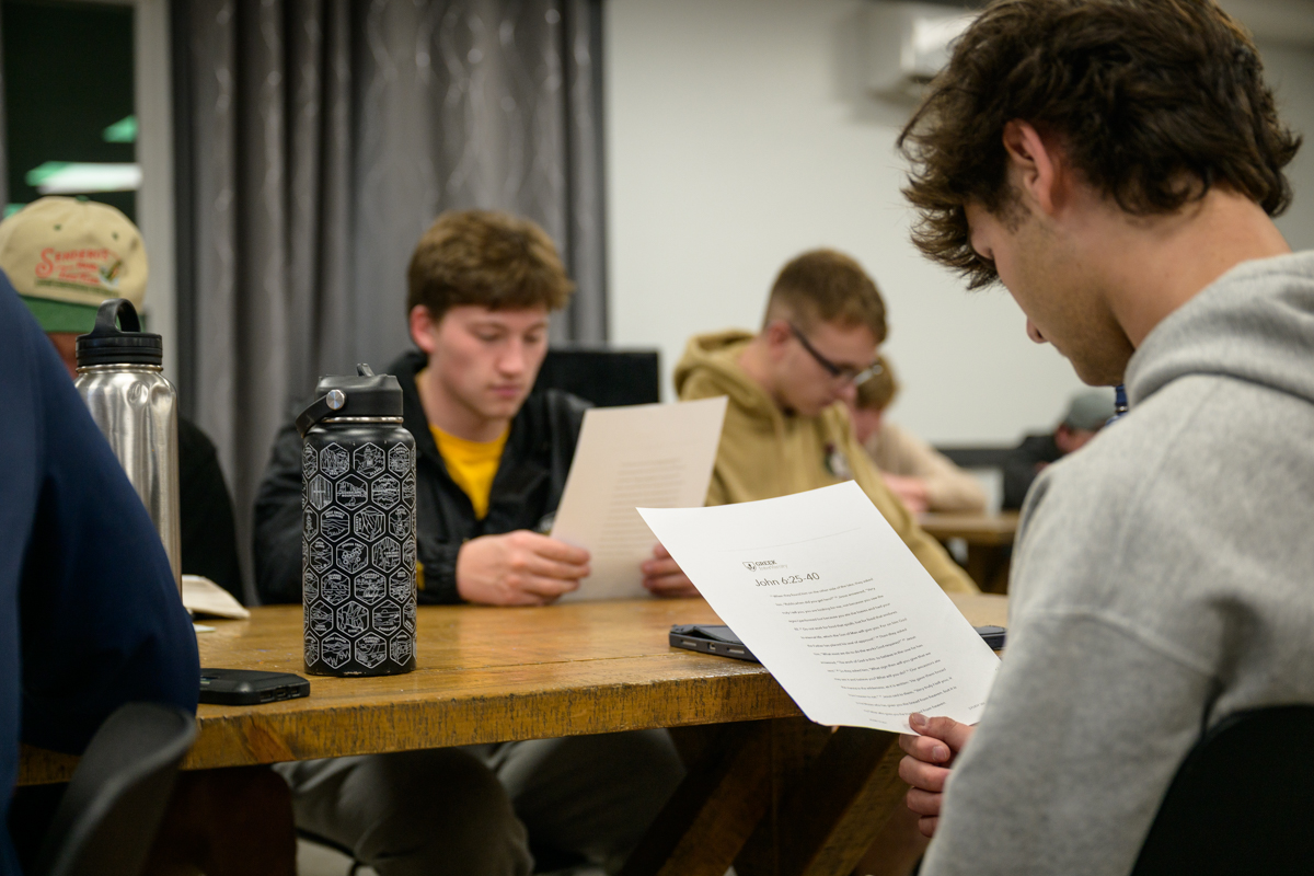 students reading a Bible passage