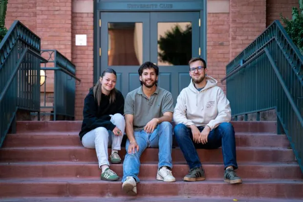 Elijah sitting on steps with two friends