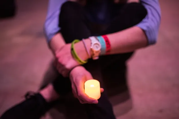 hand holding tea light