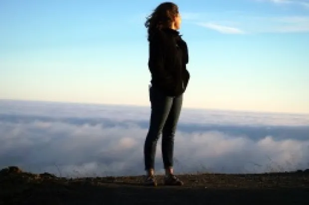 Woman standing on ridge overlooking mountains