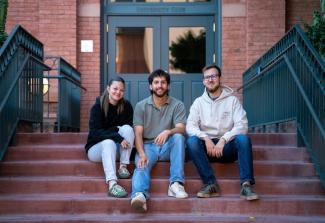 Elijah sitting on steps with two friends