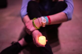hand holding tea light