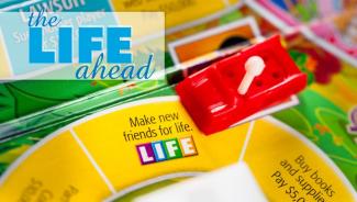 Life board game on the Make New Friends for Life square with the words "The Life Ahead" in the background.