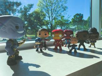 Avengers action figures clustered around large giant Thanos character