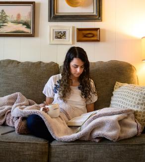 woman sitting on the couch and reading