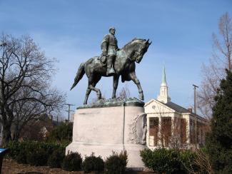 Statue of Robert E. Lee on horse on pedestal in park