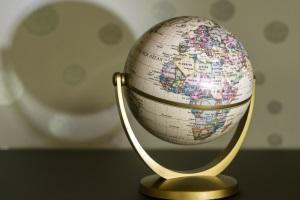 Globe sitting on counter with its shadow spreading across the wall