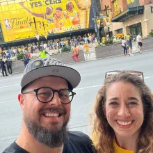 Andrew & Steph smiling while at a sports event