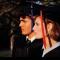 side view of two students in graduation caps