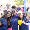 3 smiling female students and a yellow contact card