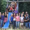Large group of college students gathered around a playground slide