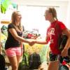 Two students shaking hands in a dorm room